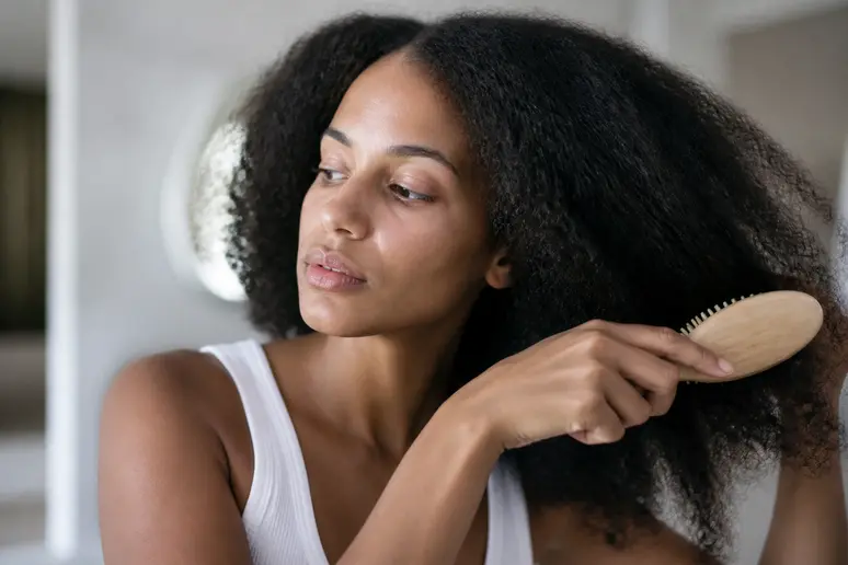 Brossage délicat des cheveux mousseux avec une brosse adaptée pour éviter la casse