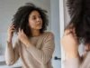 Cheveux mousseux : 5 gestes pour les dompter au naturel Conseils pratiques pour savoir comment dompter cheveux mousseux avec des soins naturels dans une salle de bain lumineuse.